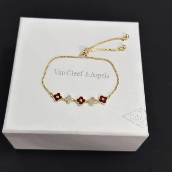 Van Cleef Arpels Alhambra bracelet yellow gold metal burgundy carnelian clover inlays clear diamond accents adjustable sliding chain maximum length 22cm