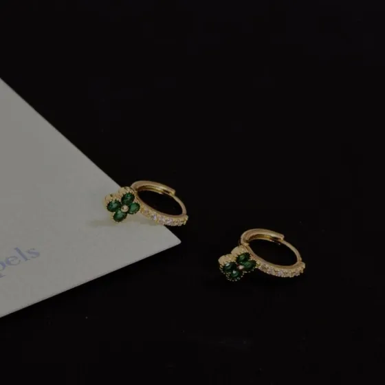 Van Cleef Arpels Alhambra earrings yellow gold metal with green gemstone clover motifs and clear diamond accents 10mm hoop diameter