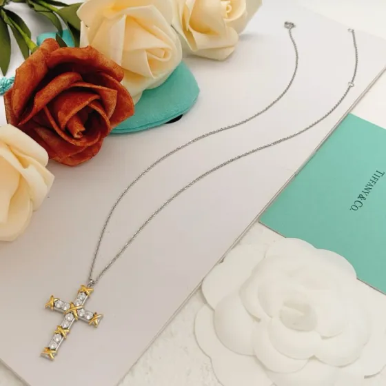 Tiffany Co Jean Schlumberger Cross Pendant necklace Sterling silver and 18k yellow gold with clear round diamonds 18 inches