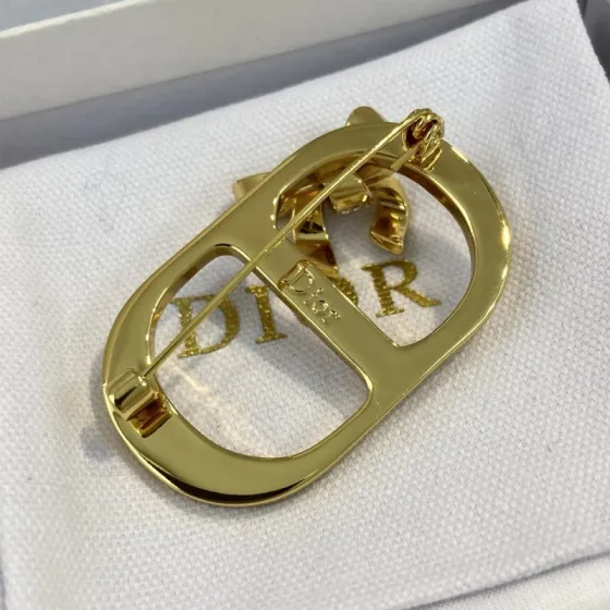 Dior CD Logo Bow Brooch brooch gold-tone metal clear crystal rhinestones white mother-of-pearl inlay 3 5cm width
