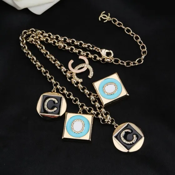 Chanel CC Logo COCO Charm Pendant Chain necklace Gold-tone metal with black enamel turquoise enamel white enamel and crystal accents 40cm with 5cm extender