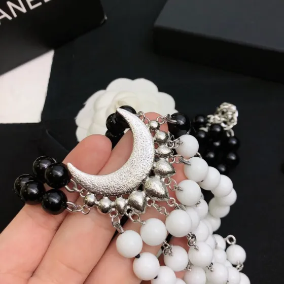 Chanel Baroque Crescent Moon CC Logo necklace silver tone metal black resin beads white resin beads clear crystal accents 42cm with 5cm extender chain