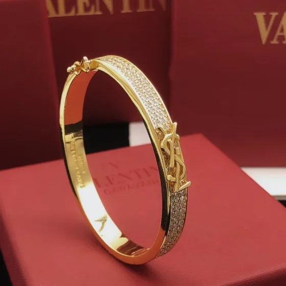 Saint Laurent Cassandre Monogram Pave Bangle bracelet gold-tone metal with clear pave crystals 17cm inner circumference