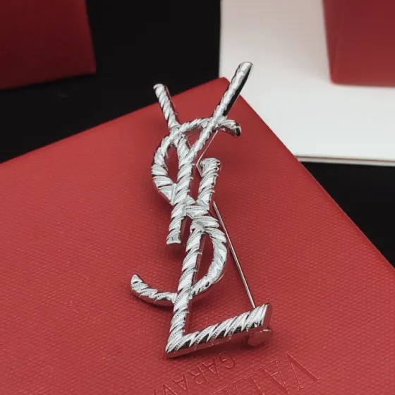 Saint Laurent Cassandre Twisted Monogram brooch silver tone metal no gemstones 4 5cm height