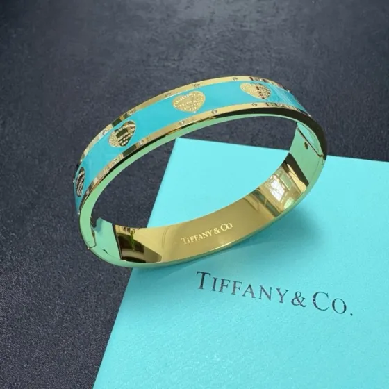 Tiffany Co Return to Tiffany Heart Tag Enamel Bangle bracelet Gold-tone metal with Tiffany Blue Blush Pink and Black enamel accented with gold heart motifs and small clear crystal details 17cm inner circumference