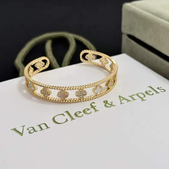 Van Cleef Arpels Alhambra Four-Leaf Clover Open Cuff bracelet Yellow gold metal with white mother-of-pearl and clear diamond accents 17cm inner circumference