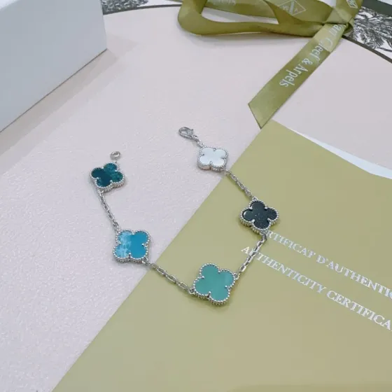 Van Cleef Arpels Alhambra bracelet Silver-toned metal with white mother-of-pearl black onyx turquoise blue agate and dark teal chalcedony clover motifs 17cm