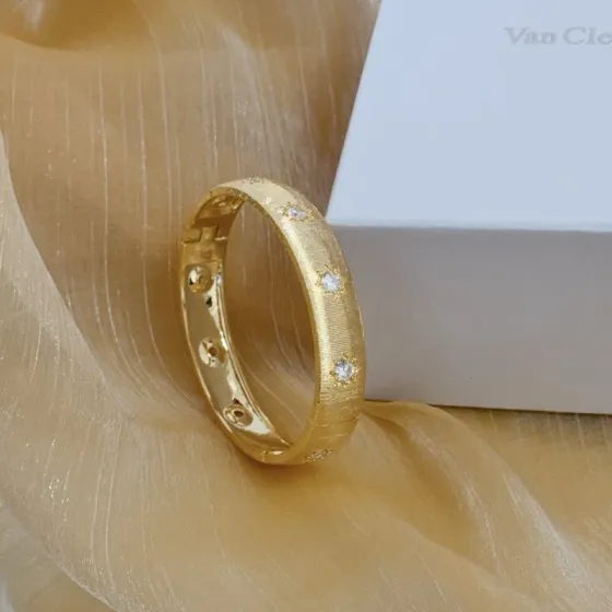 Van Cleef Arpels Four-Leaf Clover Lucky Pattern Multi-layered Carved Bangle bracelet yellow gold metal with clear diamond-like accent stones 17cm inner circumference