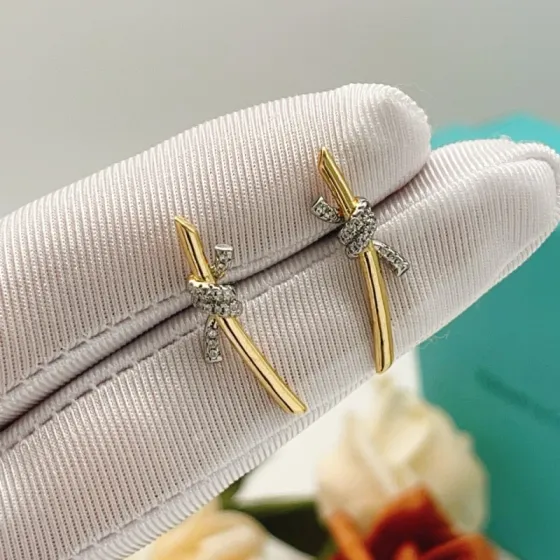 Tiffany Co Knot earrings yellow gold metal with white gold diamond-accented knot clear diamond stones 15mm length