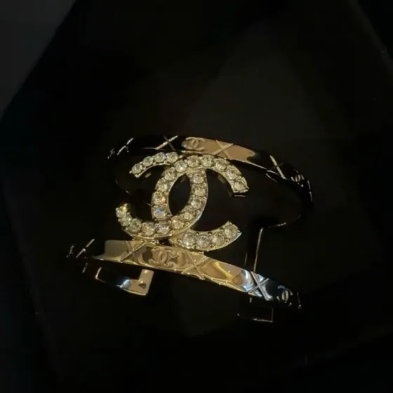 Chanel CC Logo Quilted Crystal Cuff bracelet gold-tone metal with clear crystal accents 17cm inner circumference