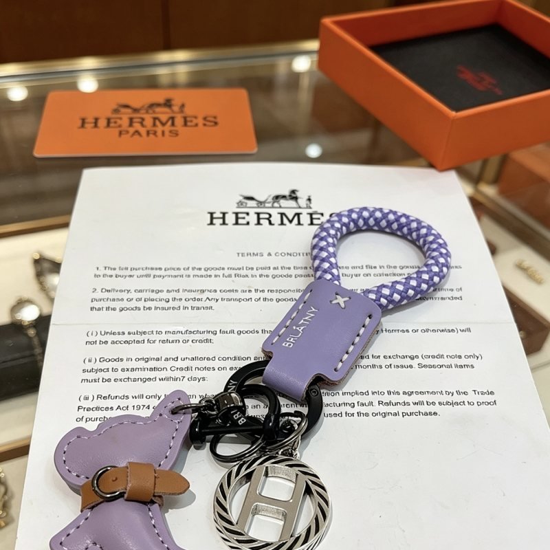 Hermes Rodeo H Logo Key Charm pendant Lilac purple leather purple and white braided cord tan leather accent gunmetal silver-tone metal with black enamel detailing 10cm total length
