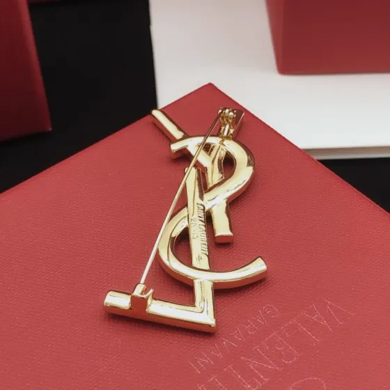 Saint Laurent Cassandre YSL Monogram brooch gold-tone metal with clear round and baguette-cut crystals 4 5cm