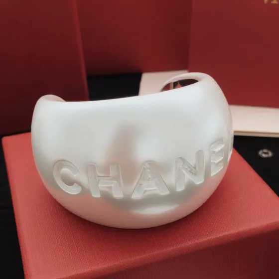 Chanel Embossed Logo Wide Cuff bracelet Pearlescent white resin with silver-tone metal inner lining One Size 6 5cm inner diameter
