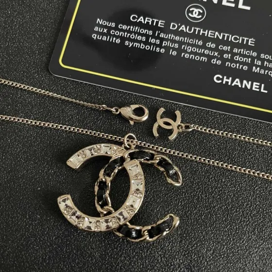 Chanel CC Logo Crystal Leather Woven Pendant Necklace necklace Gold-tone metal with clear faceted crystals and black woven leather accents 42cm
