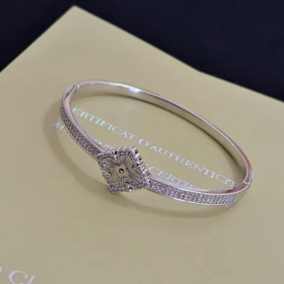 Van Cleef Arpels Alhambra bracelet silver-toned metal with clear diamond accents and grey engraved clover motif 17cm