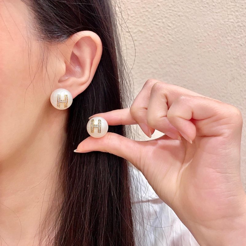 Hermes H Logo Pearl Stud Earrings earrings Cream white pearl base gold-tone metal H logo with clear crystal accents 12mm diameter