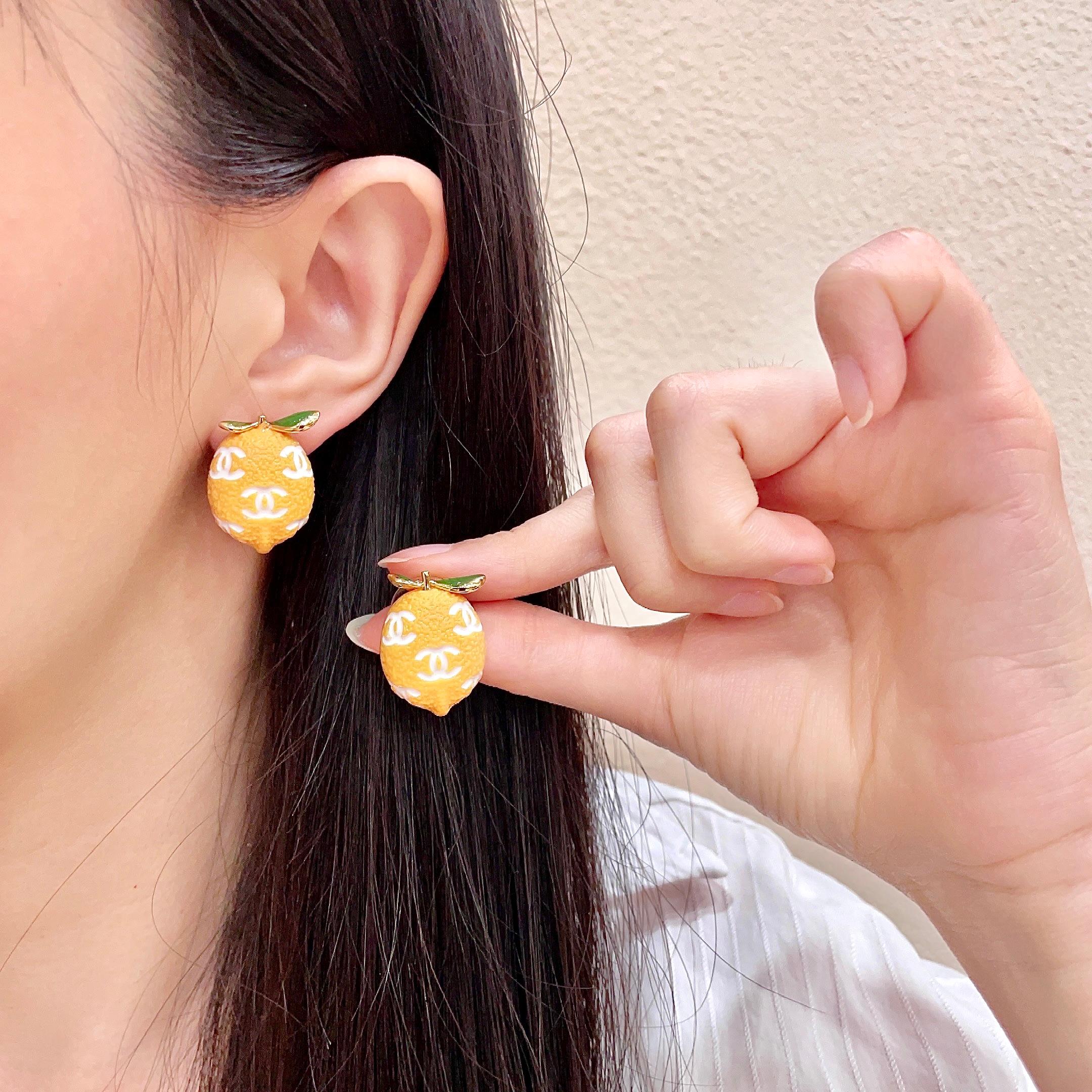 Chanel CC Lemon Fruit Stud Earrings earrings Gold tone metal yellow enamel lemon body white enamel CC logos green enamel leaves 1 5cm stud diameter
