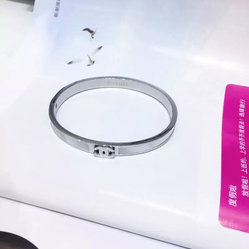 Chanel CC Logo Hinged Bangle bracelet Gold-tone metal with white mother-of-pearl inlay Rose gold-tone metal with white mother-of-pearl inlay Silver-tone metal with white enamel inlay 17cm inner circumference