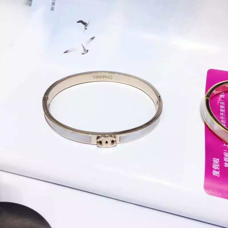 Chanel CC Logo Hinged Bangle bracelet Gold-tone metal with white mother-of-pearl inlay Rose gold-tone metal with white mother-of-pearl inlay Silver-tone metal with white enamel inlay 17cm inner circumference