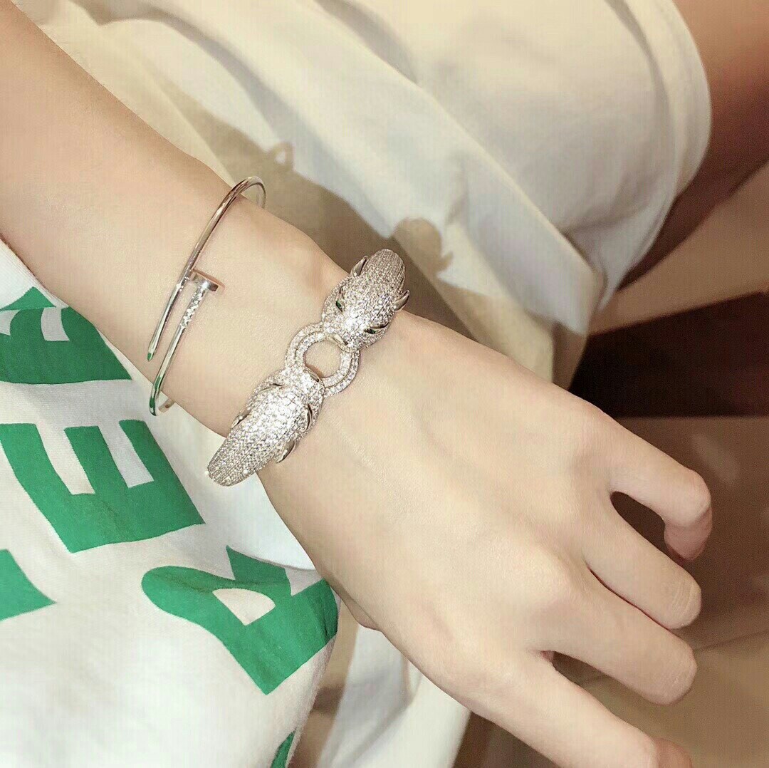 Cartier Panthere de Cartier bracelet 18K white gold pave set diamonds emerald green panther eyes black onyx accents 17cm
