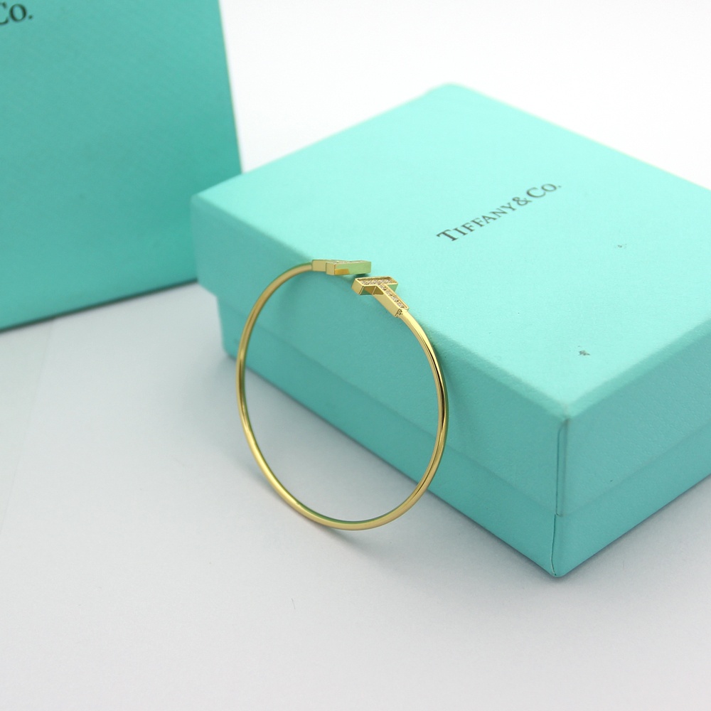 Tiffany Tiffany T bracelet Available in 18k rose gold 18k yellow gold and sterling silver all set with clear round brilliant diamonds 17cm inner circumference