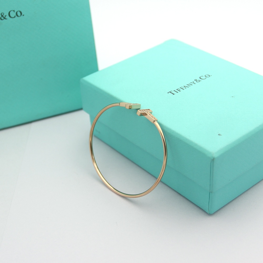 Tiffany Tiffany T bracelet Available in 18k rose gold 18k yellow gold and sterling silver all set with clear round brilliant diamonds 17cm inner circumference
