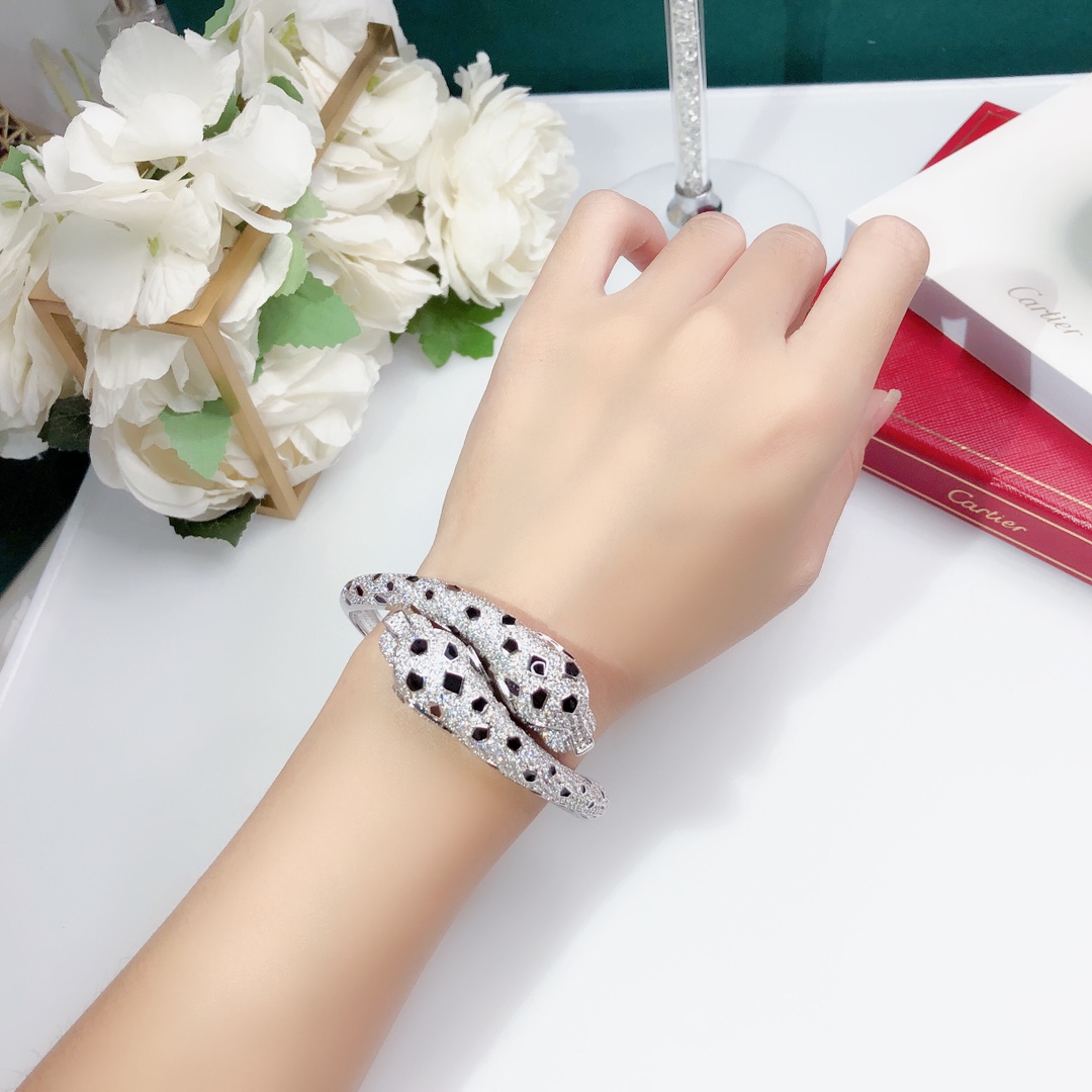 Cartier Panthere de Cartier bracelet 18K white gold set with colorless diamonds black onyx spots green tsavorite garnet eyes 17cm inner circumference