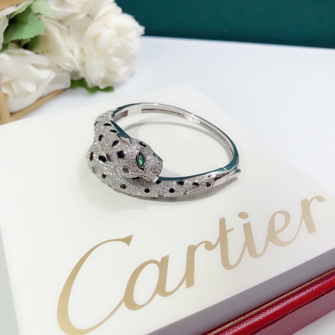 Cartier Panthere de Cartier bracelet 18K white gold set with colorless diamonds black onyx spots green tsavorite garnet eyes 17cm inner circumference