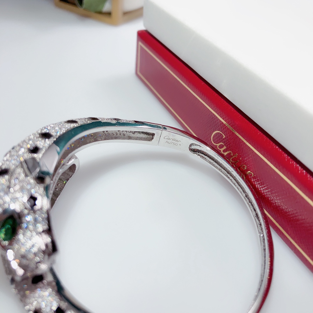 Cartier Panthere de Cartier bracelet 18K white gold set with colorless diamonds black onyx spots green tsavorite garnet eyes 17cm inner circumference
