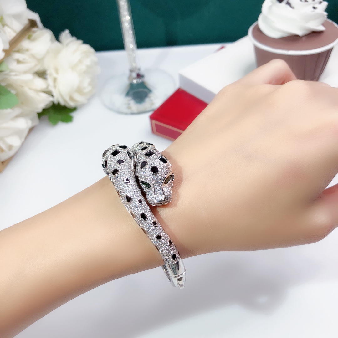 Cartier Panthere de Cartier bracelet 18K white gold set with colorless diamonds black onyx spots green tsavorite garnet eyes 17cm inner circumference