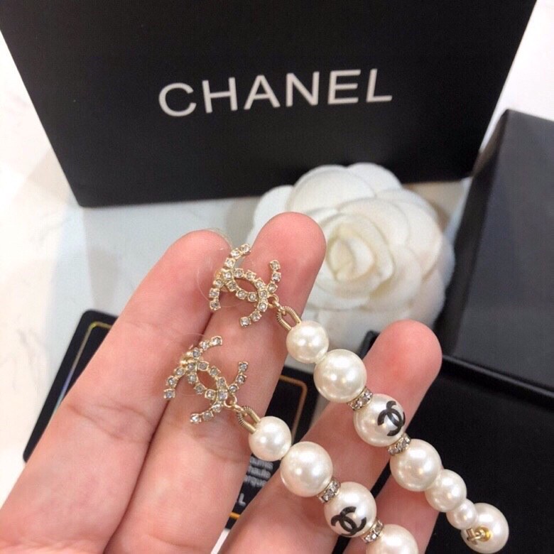 Chanel CC Logo Graduated Pearl Drop Earrings earrings Gold-tone metal white faux pearl clear crystal black enamel CC logo 6 5cm drop length