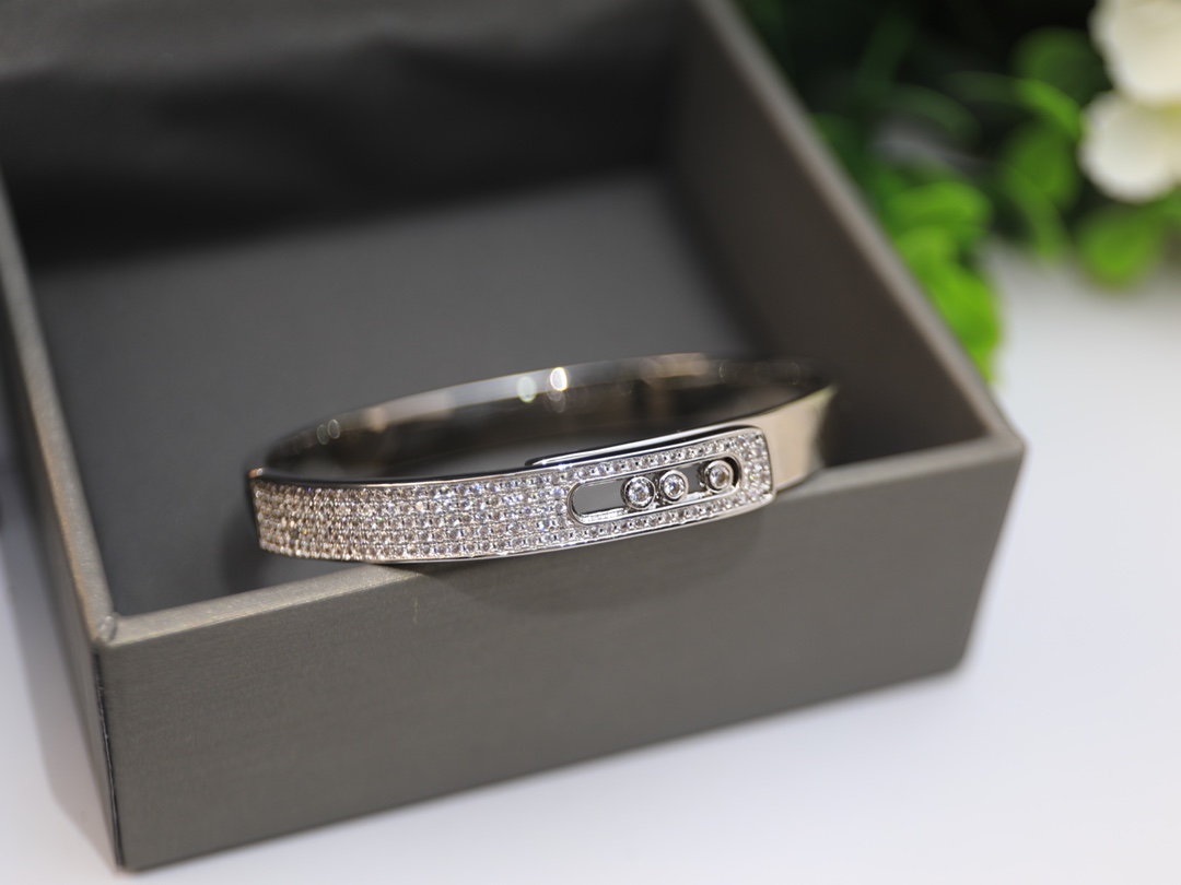 Messika Move Series Pave Bangle bracelet Available in 18k rose gold 18k yellow gold 18k white gold all set with pave white diamonds and three sliding brilliant-cut white diamonds 17cm inner circumference