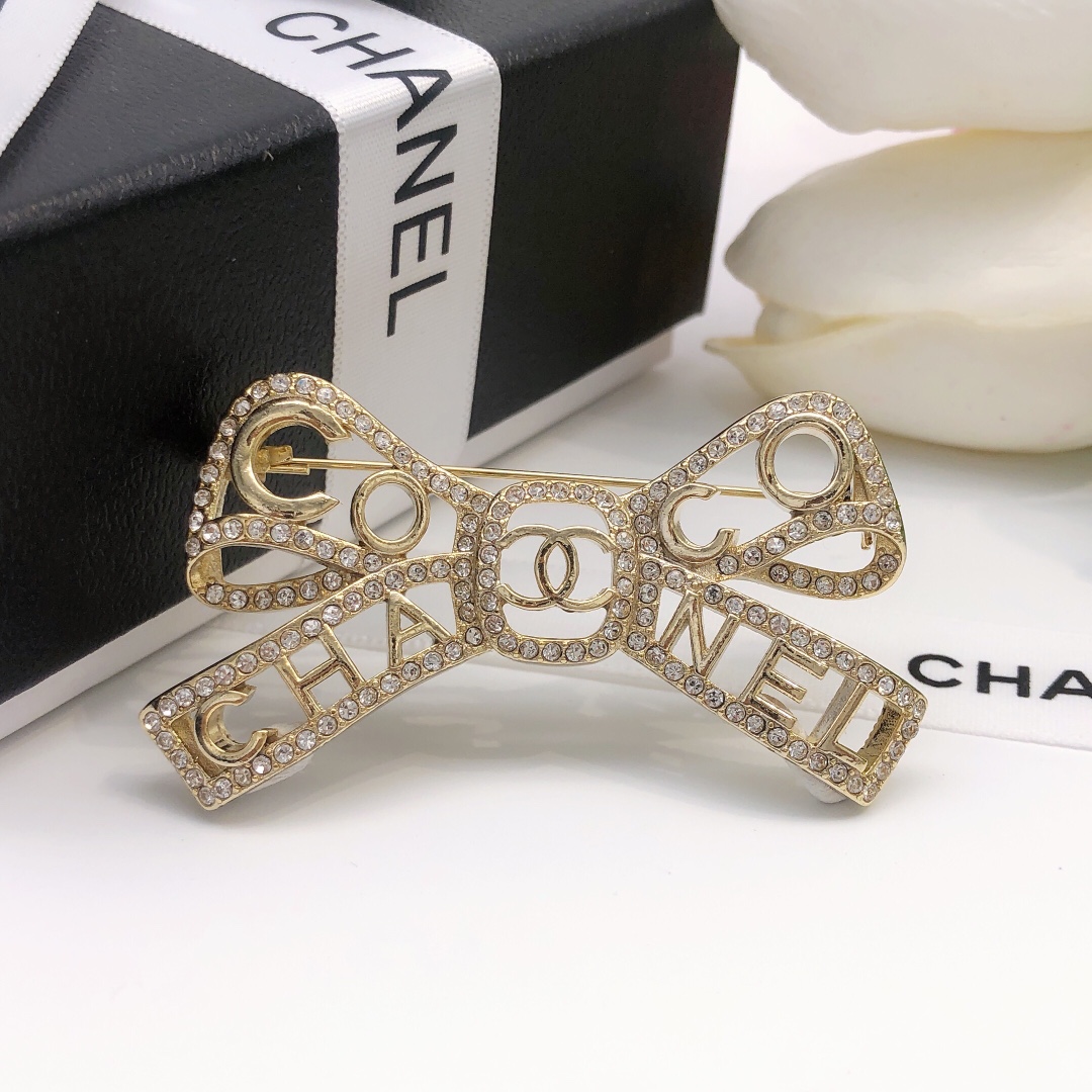 Chanel Coco Chanel Bow Logo Crystal Brooch brooch light gold tone metal with clear crystal accents 4 5cm width