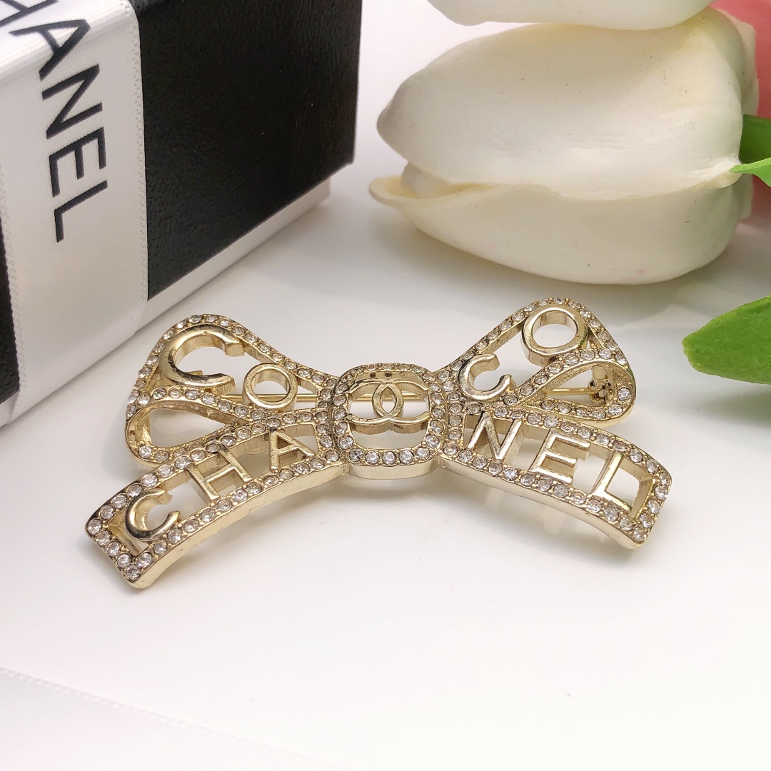 Chanel Coco Chanel Bow Logo Crystal Brooch brooch light gold tone metal with clear crystal accents 4 5cm width