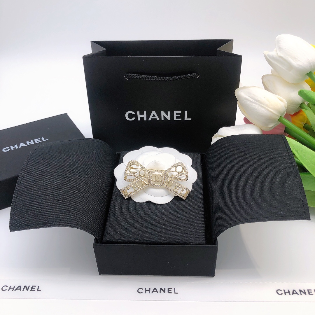 Chanel Coco Chanel Bow Logo Crystal Brooch brooch light gold tone metal with clear crystal accents 4 5cm width