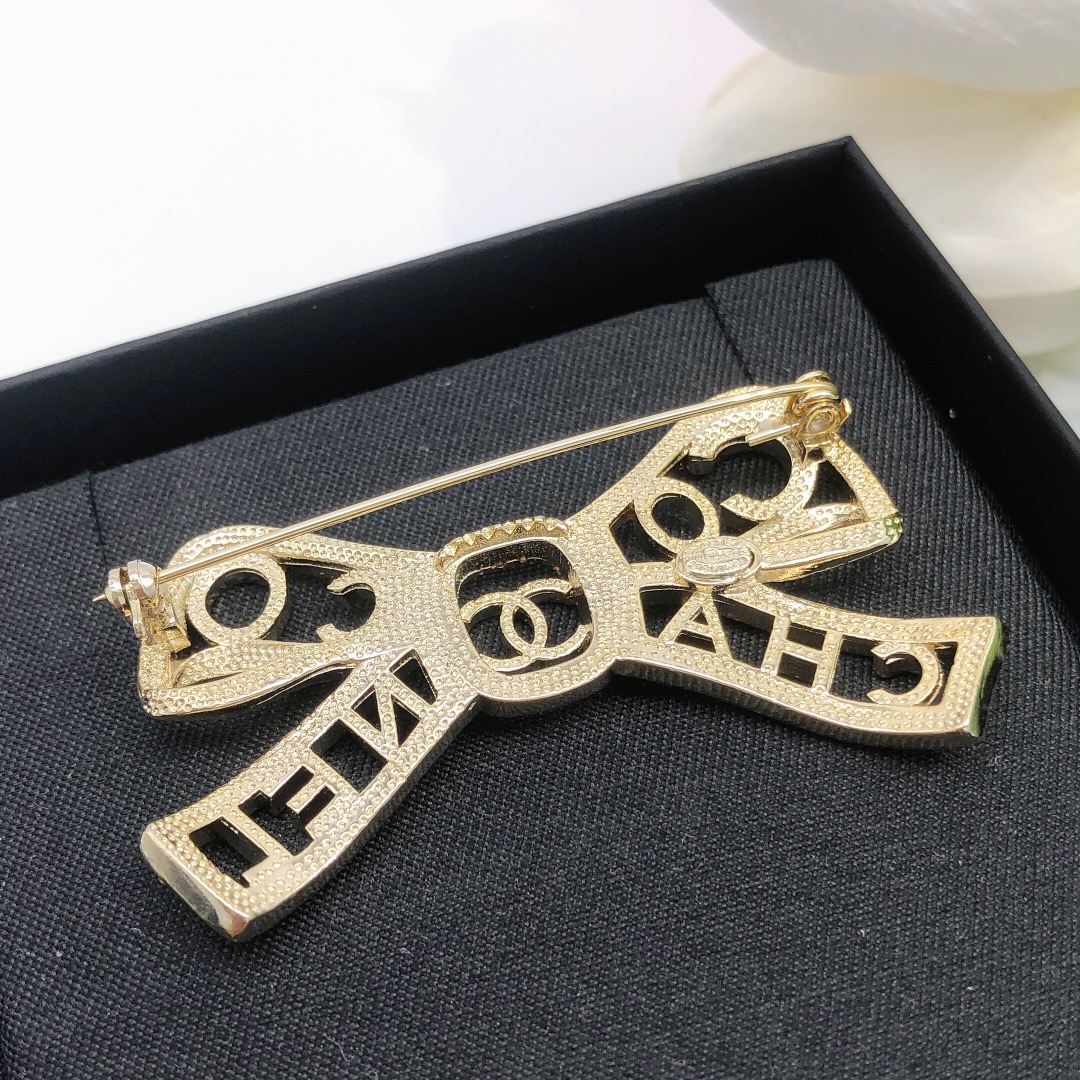 Chanel Coco Chanel Bow Logo Crystal Brooch brooch light gold tone metal with clear crystal accents 4 5cm width