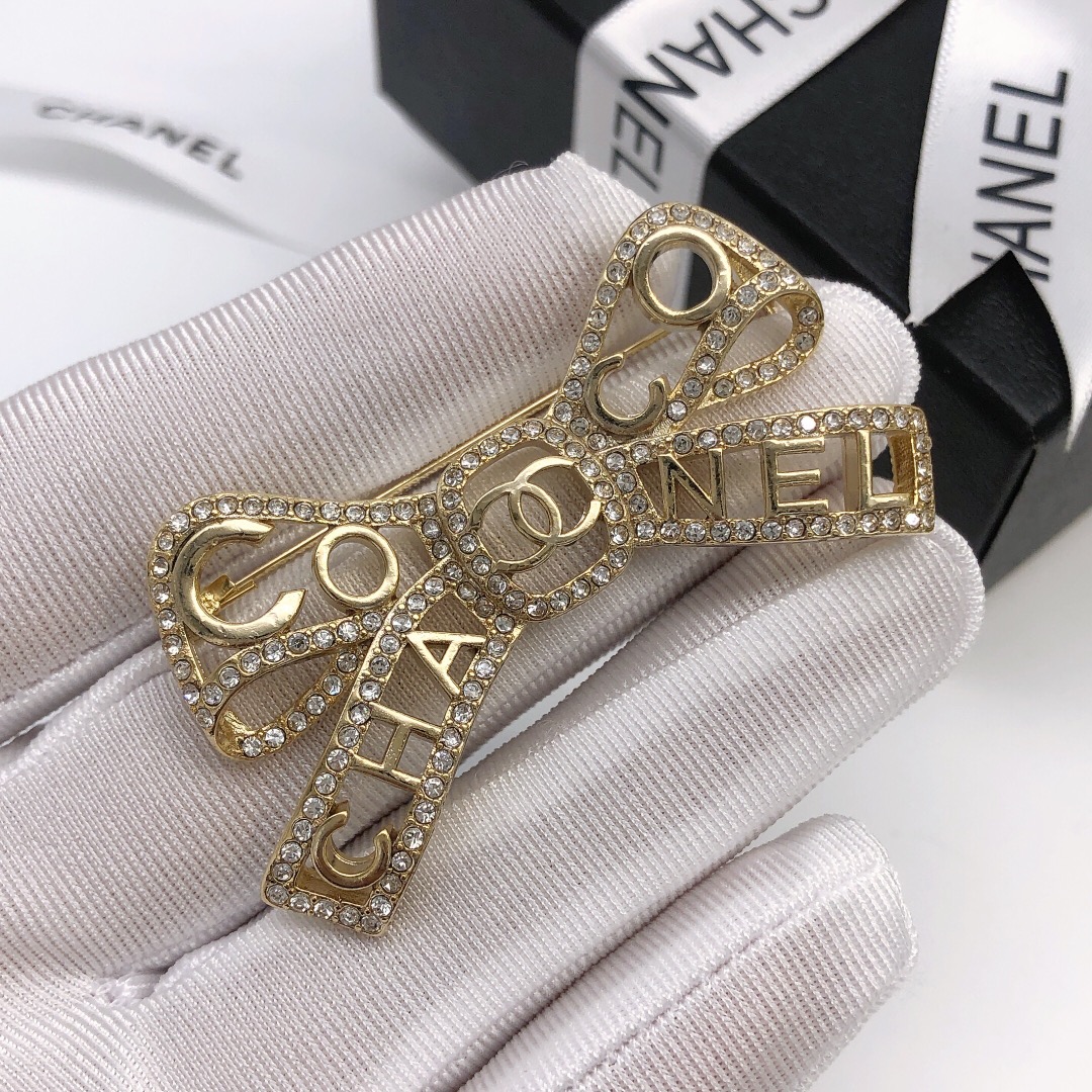 Chanel Coco Chanel Bow Logo Crystal Brooch brooch light gold tone metal with clear crystal accents 4 5cm width