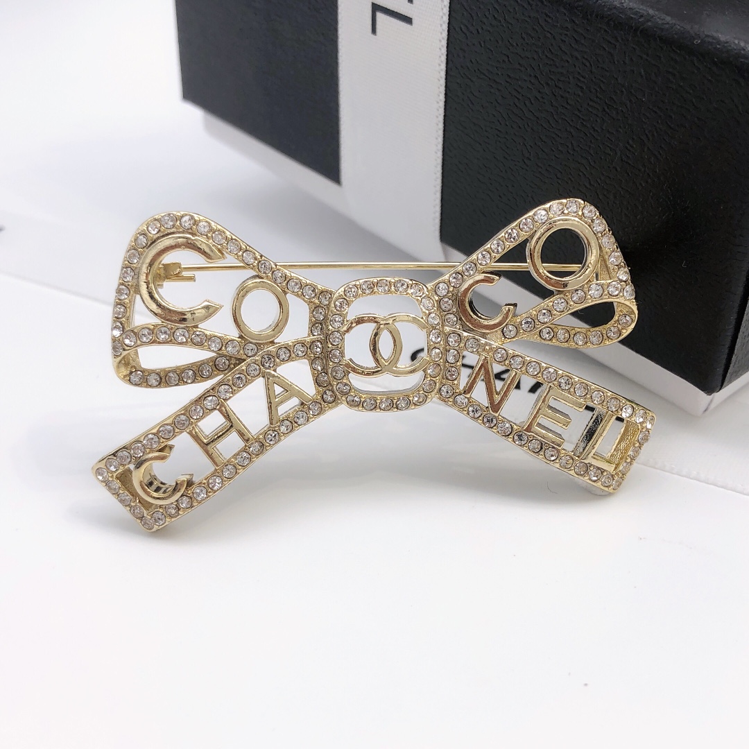 Chanel Coco Chanel Bow Logo Crystal Brooch brooch light gold tone metal with clear crystal accents 4 5cm width