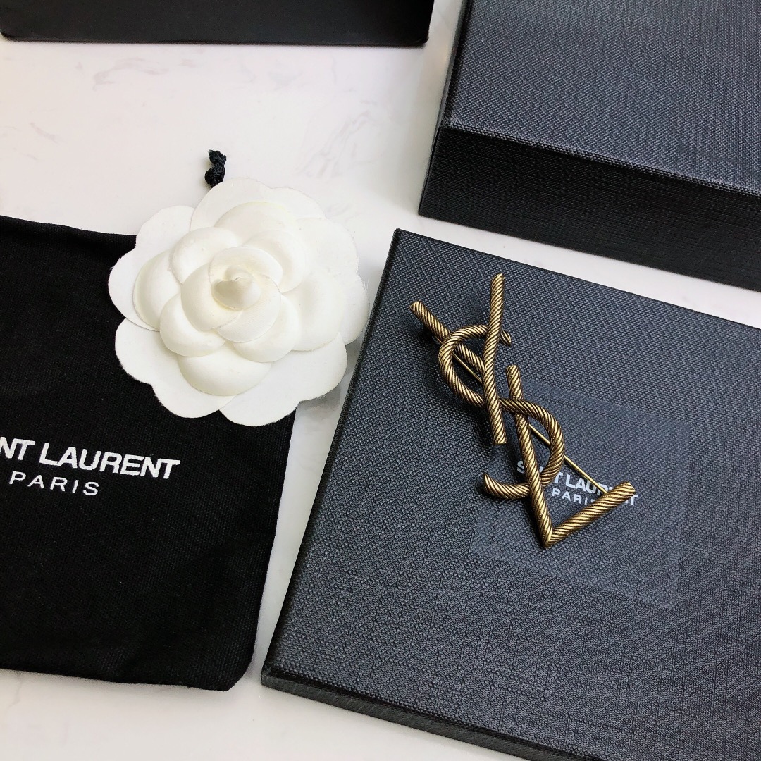 Saint Laurent Cassandre Twisted Monogram Brooch brooch antique brass gold metal no gemstones 4 5cm width
