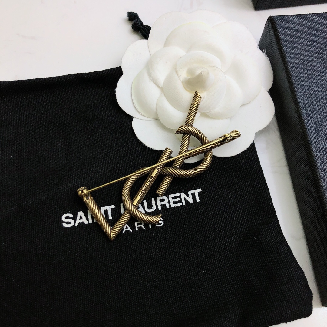Saint Laurent Cassandre Twisted Monogram Brooch brooch antique brass gold metal no gemstones 4 5cm width