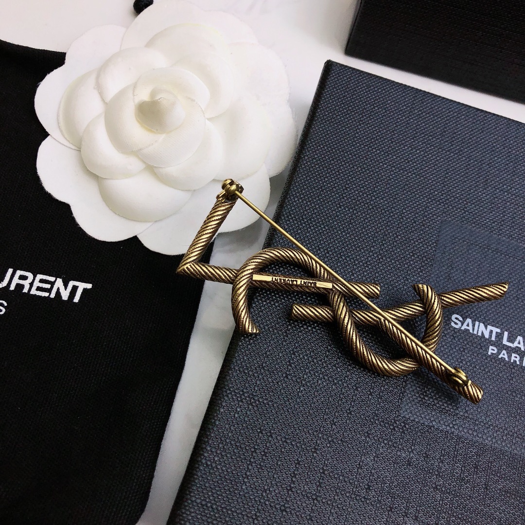 Saint Laurent Cassandre Twisted Monogram Brooch brooch antique brass gold metal no gemstones 4 5cm width