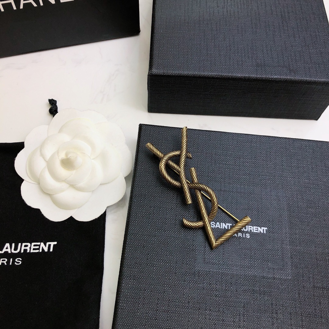 Saint Laurent Cassandre Twisted Monogram Brooch brooch antique brass gold metal no gemstones 4 5cm width
