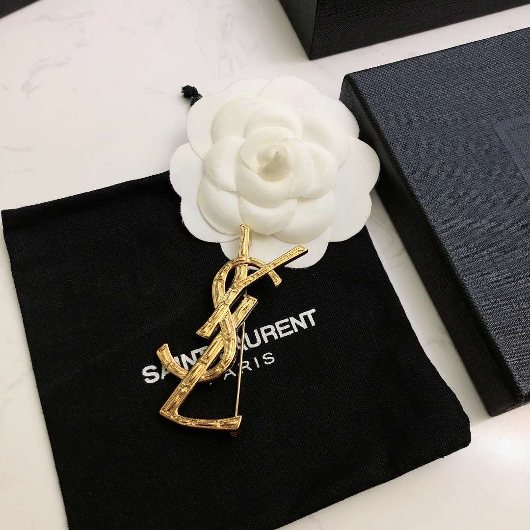 Saint Laurent Cassandre Bamboo YSL Monogram brooch gold tone metal no gemstones 4 5cm height