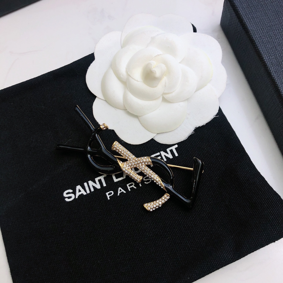 Saint Laurent 05038100 YSL Monogram brooch Gold-tone metal black enamel clear crystal pave 4 5cm width