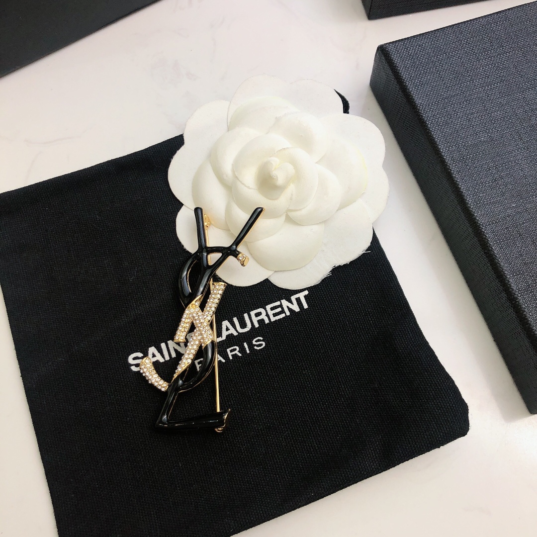 Saint Laurent 05038100 YSL Monogram brooch Gold-tone metal black enamel clear crystal pave 4 5cm width