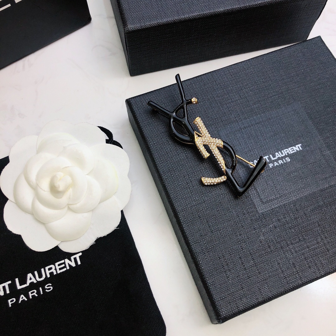 Saint Laurent 05038100 YSL Monogram brooch Gold-tone metal black enamel clear crystal pave 4 5cm width