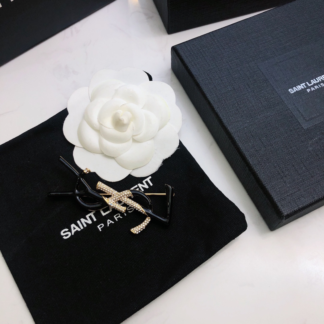 Saint Laurent 05038100 YSL Monogram brooch Gold-tone metal black enamel clear crystal pave 4 5cm width