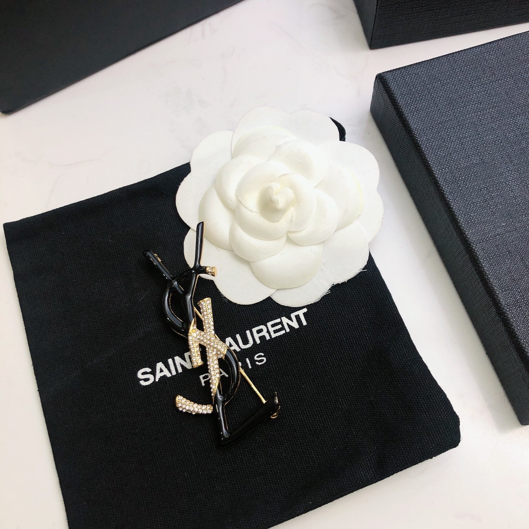 Saint Laurent 05038100 YSL Monogram brooch Gold-tone metal black enamel clear crystal pave 4 5cm width