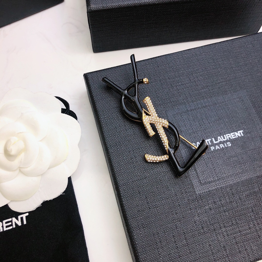 Saint Laurent 05038100 YSL Monogram brooch Gold-tone metal black enamel clear crystal pave 4 5cm width