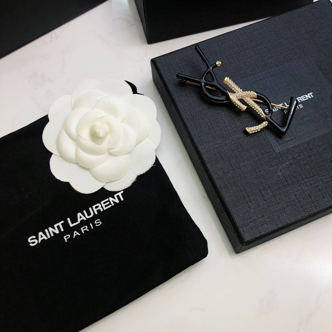 Saint Laurent 05038100 YSL Monogram brooch Gold-tone metal black enamel clear crystal pave 4 5cm width